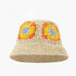 Beige crochet bucket hat with bright orange, yellow, and blue granny square floral patterns, labeled UPF50+ for sun protection.