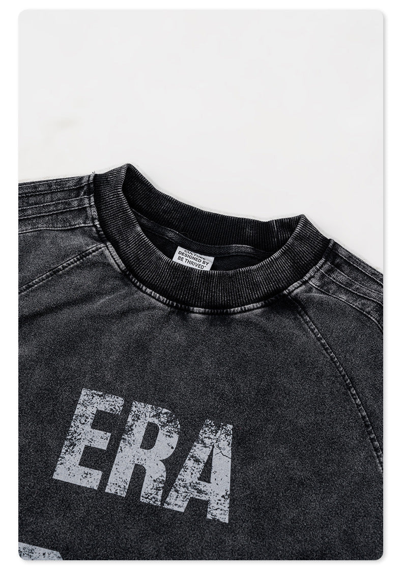 Close-up of black sweatshirt neckline showing 'BE THRIVED' label and 'ERA' distressed print