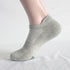 Gray athletic ankle sock on mannequin foot with ribbed support zones