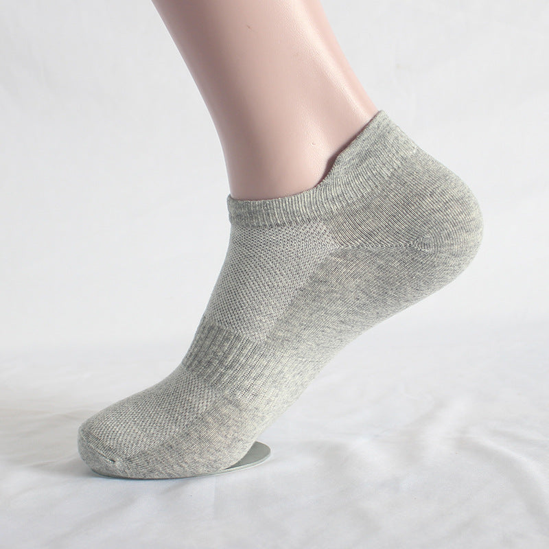 Gray athletic ankle sock on mannequin foot with ribbed support zones