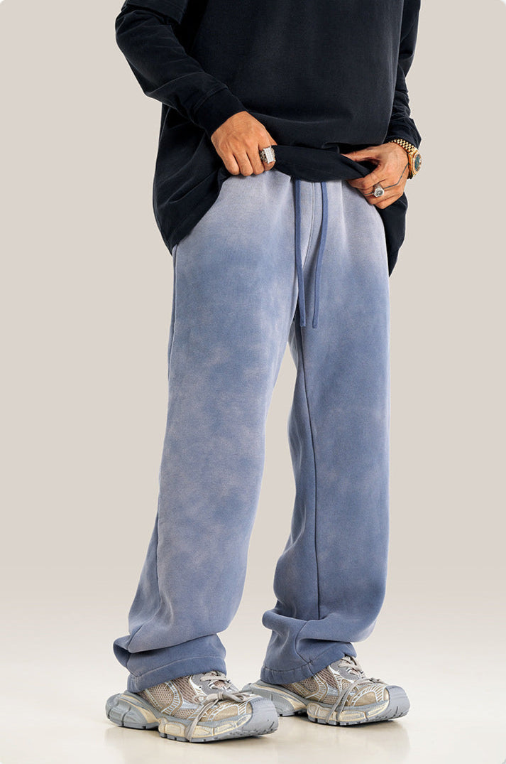Close-up of hand in pocket of light blue sweatpants with black oversized sweatshirt