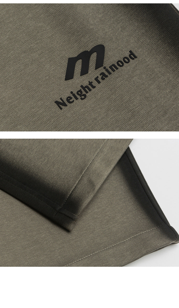 Close-up of brand logo on gray pants with "Neightrainood" printed in black