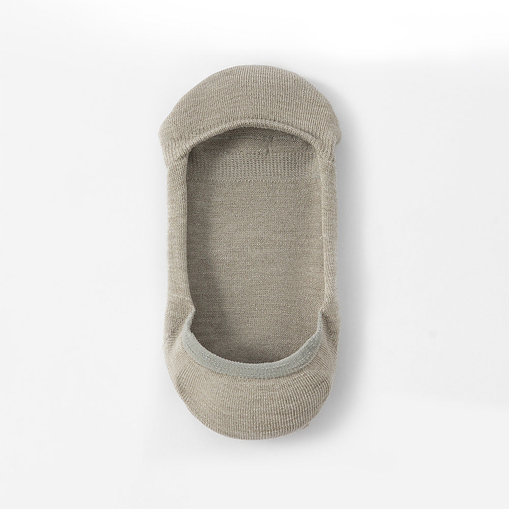 Gray no-show sock liner photographed from wearing angle, showing interior construction