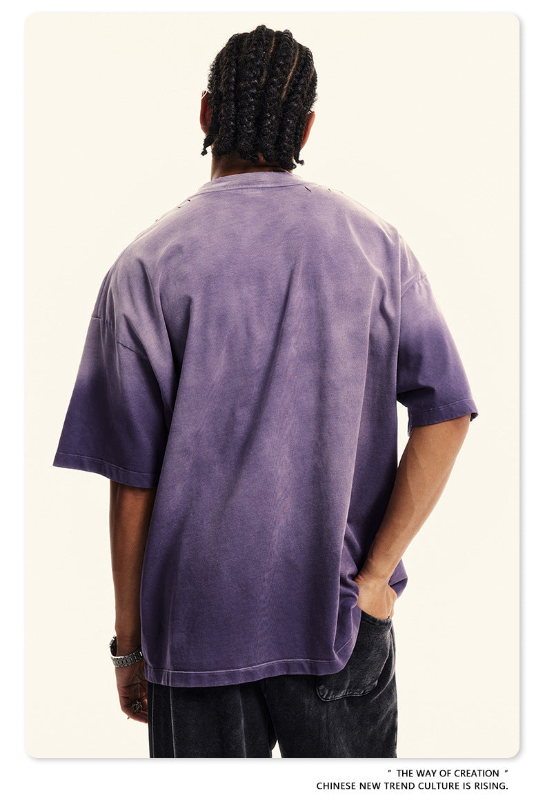 Side profile of Breaking Tradition purple tee with metal-inspired logo and comfortable relaxed fit