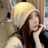 Beige knit beanie hat in car selfie with natural lighting