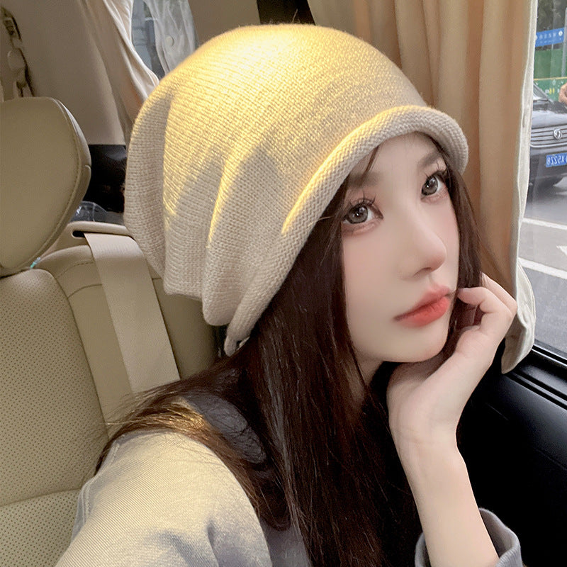 Beige knit beanie hat in car selfie with natural lighting