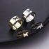 Collection of butterfly rings in gold and silver finishes shown on black surface: two wide bands and two delicate bands