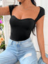 Front view: Black cap sleeve bodysuit with a sweetheart neckline, structured design, and high-waisted light wash jeans.