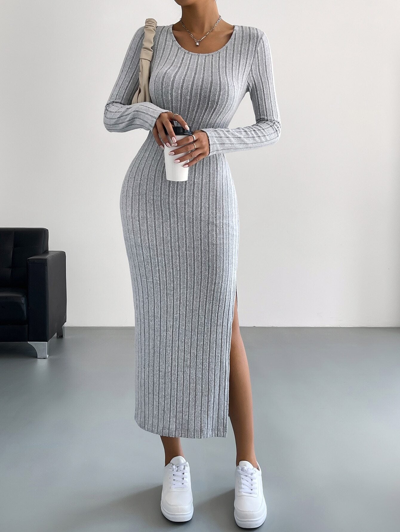 Light gray ribbed long-sleeve maxi dress with side slit, styled with white sneakers for casual chic look