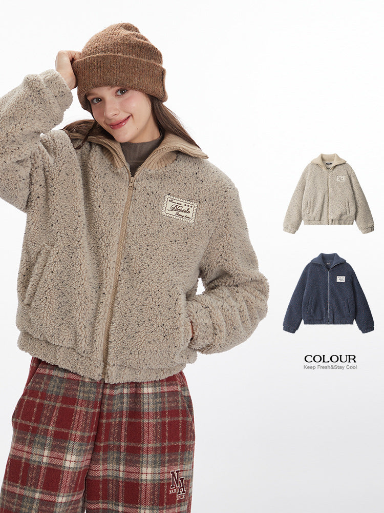 Model adjusting beanie while wearing beige sherpa jacket with Marule logo patch. Shown with color options and plaid pants