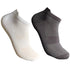 White and black low-cut ankle socks with mesh ventilation panels, cushioned soles and ribbed elastic cuffs against white background