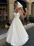 Woman in a white dress with a headscarf walking outdoors.