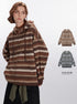 Model wearing oversized earth-tone striped hoodie with textured knit pattern paired with black skirt and olive belt, showing color options available.