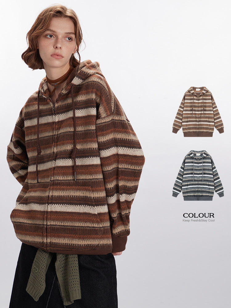 Model wearing oversized earth-tone striped hoodie with textured knit pattern paired with black skirt and olive belt, showing color options available.