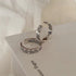 Silver adjustable rings with Roman numerals and days of week engraving paired with leaf pattern design, displayed on white page