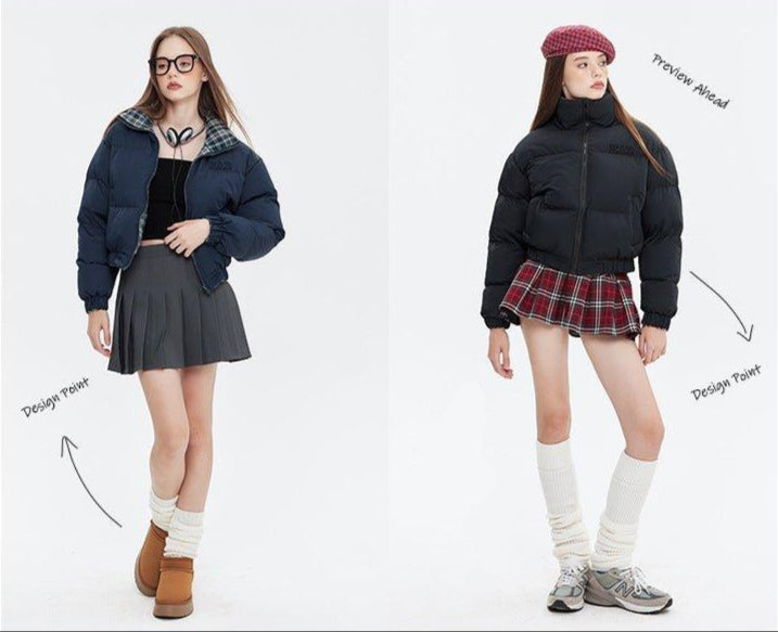 Two women pose in puffer jackets; one in navy with a gray skirt, the other in black with a red plaid skirt, against a white background