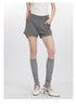 Woman wearing gray cotton shorts with pockets, styled with white tee and gray knee socks with vintage heels