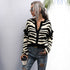 Zebra stripe cardigan, white top, ripped jeans, coffee cup, sunglasses