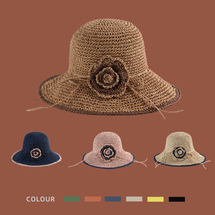 A woven sun hat in khaki with a decorative crochet flower, available in multiple colors including navy, pink, and beige.