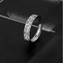 Silver band ring with intricate scroll and floral engraved pattern on dark background showcasing vintage-inspired design