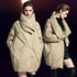 Model showing beige cocoon puffer coat from front and side views, paired with black dress and knee-high boots
