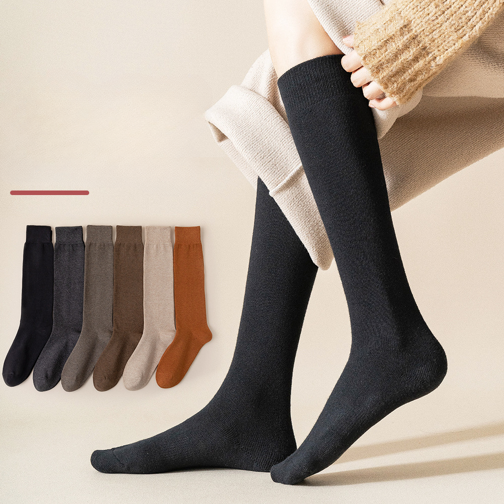 Person wearing black knee-high socks with neutral sock color options displayed on left side
