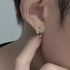 Silver star hoop earring worn on ear