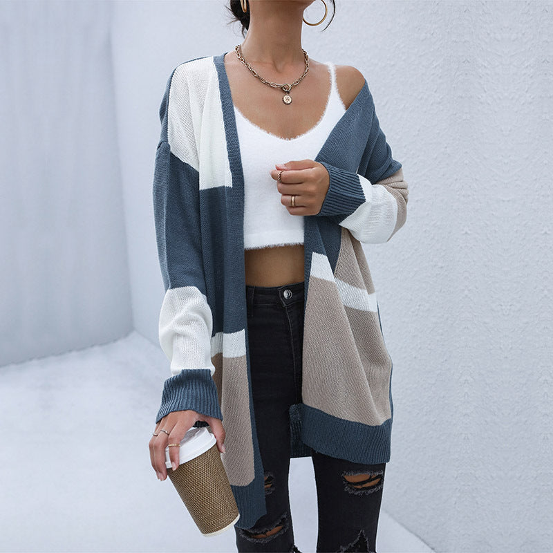 Colorblock cardigan in slate blue, beige and white, paired with white crop top and distressed black jeans