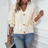 Cream knit cardigan close-up, showcasing detailed button and ribbed texture details