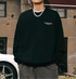 Black sweatshirt with 'Der Winter Naht' text, styled with silver chain necklace