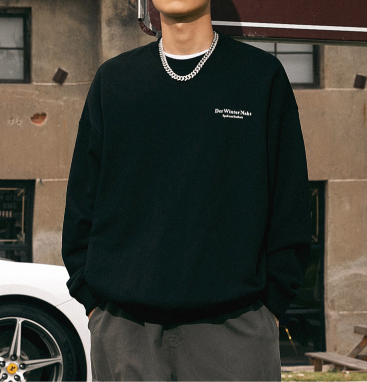 Black sweatshirt with 'Der Winter Naht' text, styled with silver chain necklace