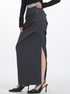 Side slit detail of dark gray midi skirt, highlighting sophisticated design and tailored silhouette