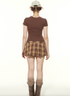 Back view of brown tee and plaid mini skirt outfit with leg warmers and boots, vintage aesthetic