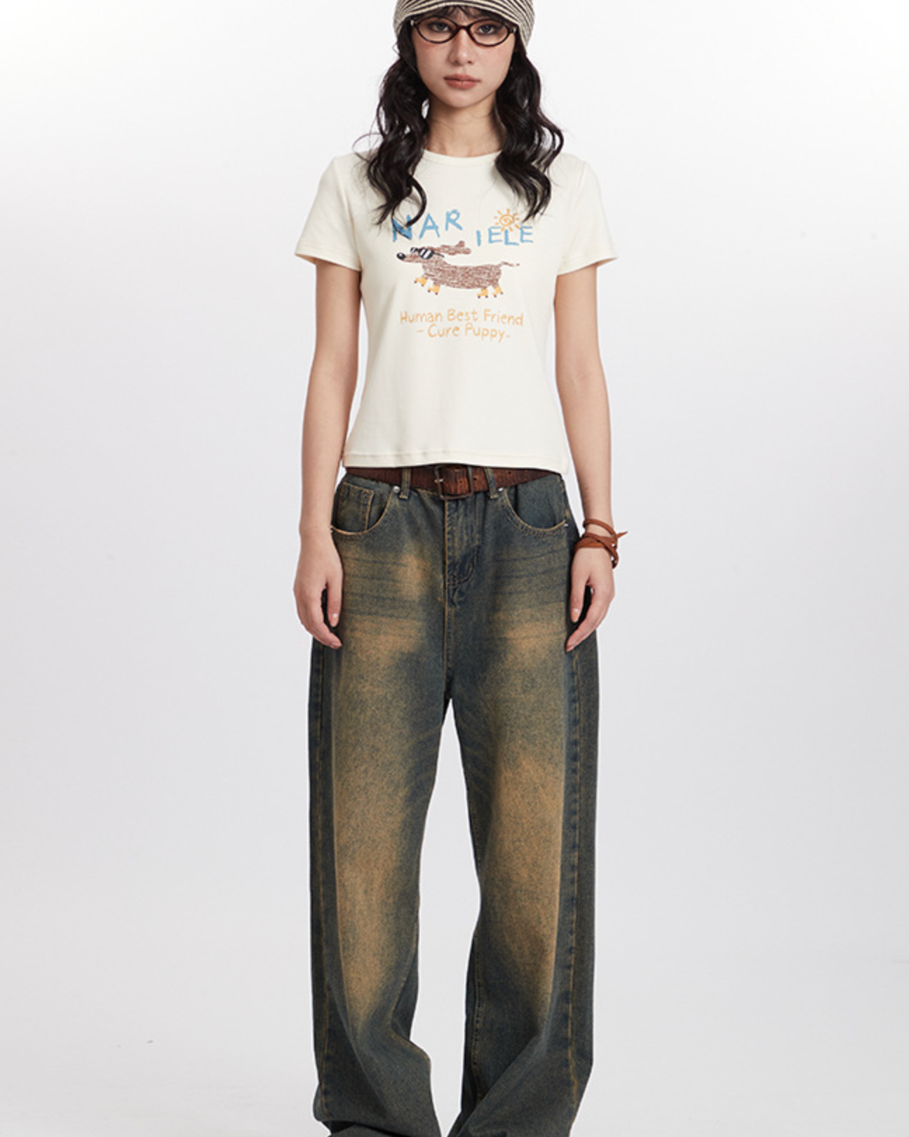 Retro streetwear outfit with striped beanie, graphic puppy tee, wide-leg distressed jeans