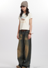 Model wearing vintage-inspired denim, dog graphic tee, striped hat in casual photoshoot