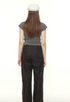 Back view of gray ruched t-shirt and black wide-leg pants outfit, showcasing casual streetwear styling with white cap