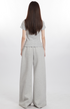 Back view of model in light gray top and wide-leg pants