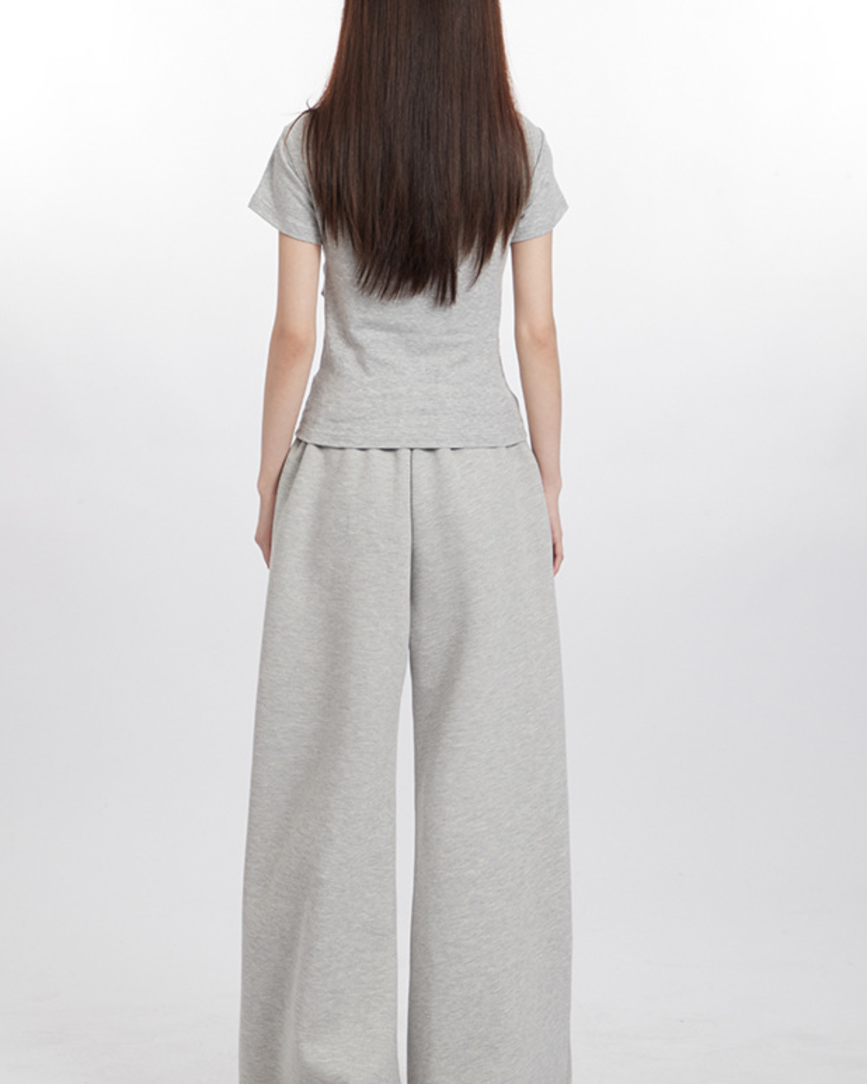 Back view of model in light gray top and wide-leg pants