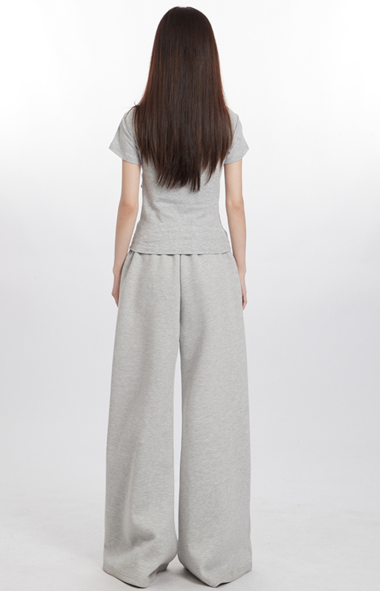 Back view of model in light gray top and wide-leg pants