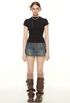 Model wearing black fitted mock neck tee with lace-up denim mini skirt and brown combat boots, accessorized with glasses