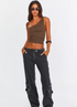 Brown asymmetrical one-shoulder top with cargo jeans, styled with sunglasses and white sneakers