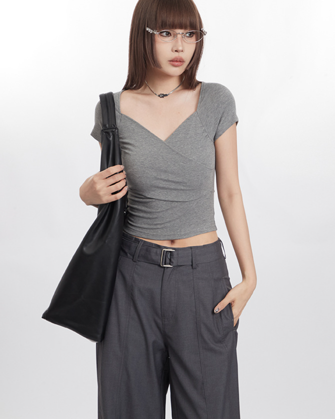 Minimalist gray outfit with a structured black tote bag