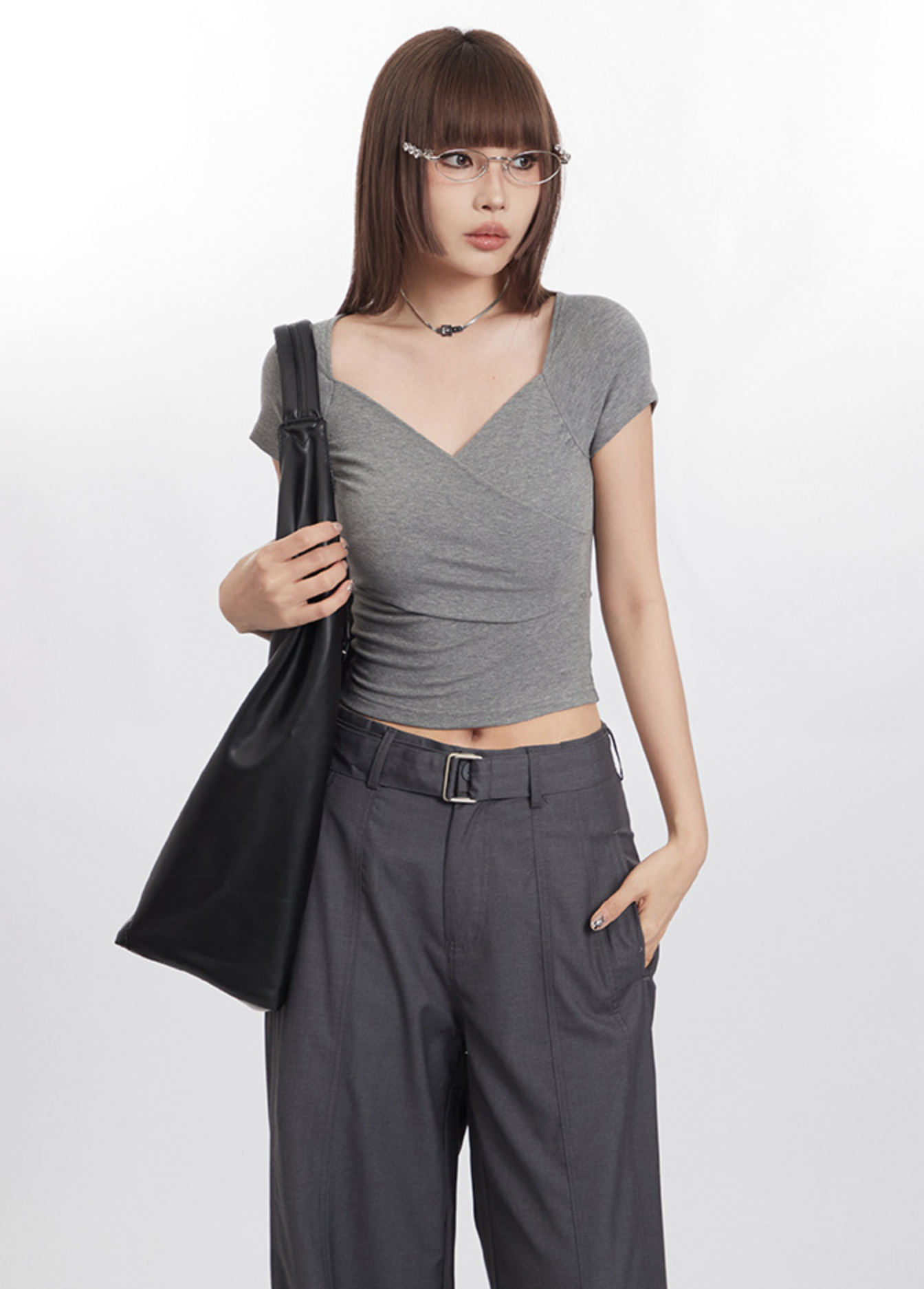 Minimalist gray outfit with a structured black tote bag
