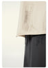 Hem detail of off-white t-shirt against charcoal gray pants