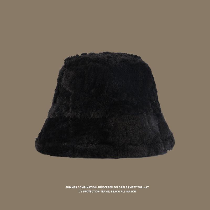 Black faux fur bucket hat with a plush finish, designed for warmth and style