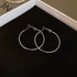 Minimalist silver thin hoop earrings in jewelry packaging