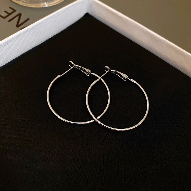 Minimalist silver thin hoop earrings in jewelry packaging