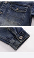 Close-up detail of denim jacket pocket flap with metal button closure and contrast stitching in gradient blue wash finish