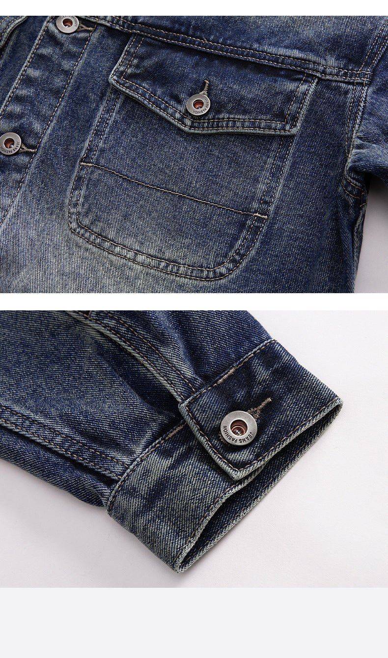 Close-up detail of denim jacket pocket flap with metal button closure and contrast stitching in gradient blue wash finish