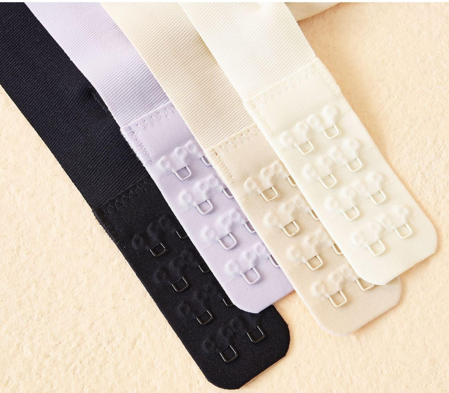 Back hook closure in four colors, offering a smooth, no-bulge fit.